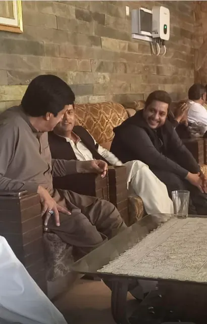 Taimoor Bamazai seated in conversation with the Governor of Punjab
