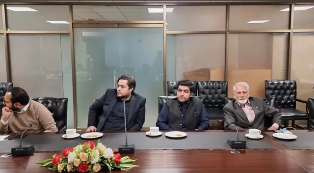 Participants seated along a conference table