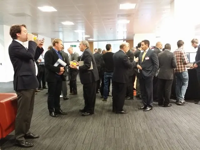 Attendees in suits talking during a networking break