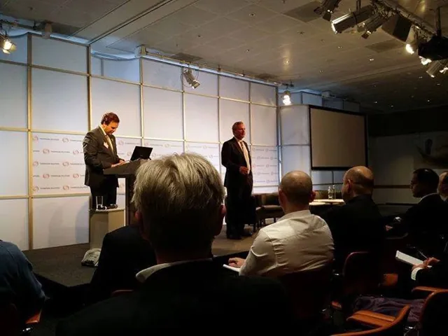 A speaker at a lectern presenting to an audience